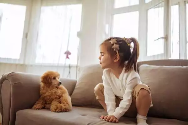 girl plays with dog during lockdown